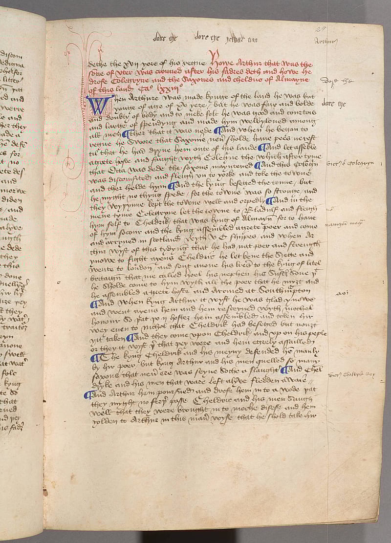 Page from an old book with hand-written text in black, red and blue ink. In the margins around the text there a notes.
