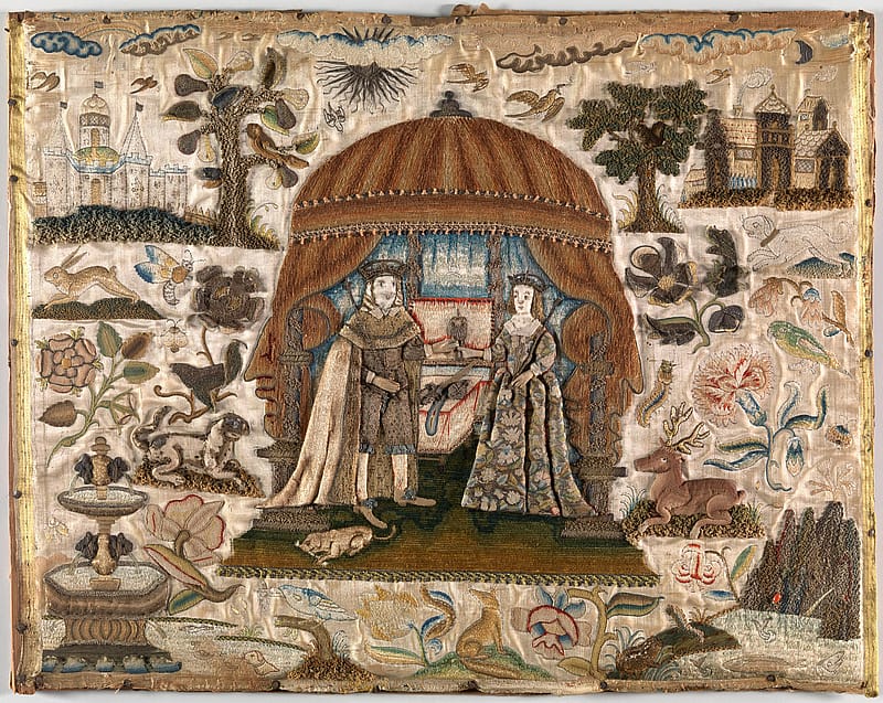 Old, discoloured embroidery of a king and a queen standing in a landscape with two trees in the background. The figures are standing at the opening of a tent. Surrounding them are icons of flaua and fauna.